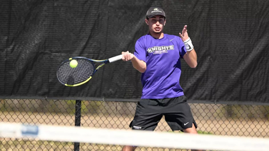 Knights men's tennis player hits the ball during a match. 